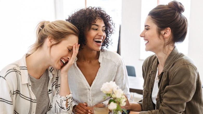 Friends laughing over coffee