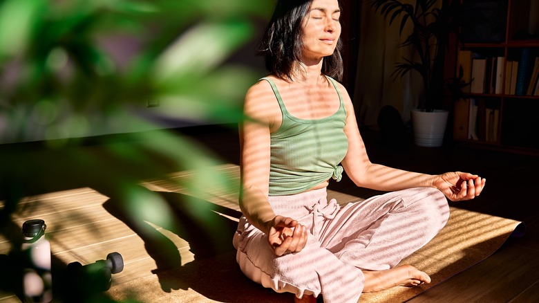 Seated woman meditating in lotus