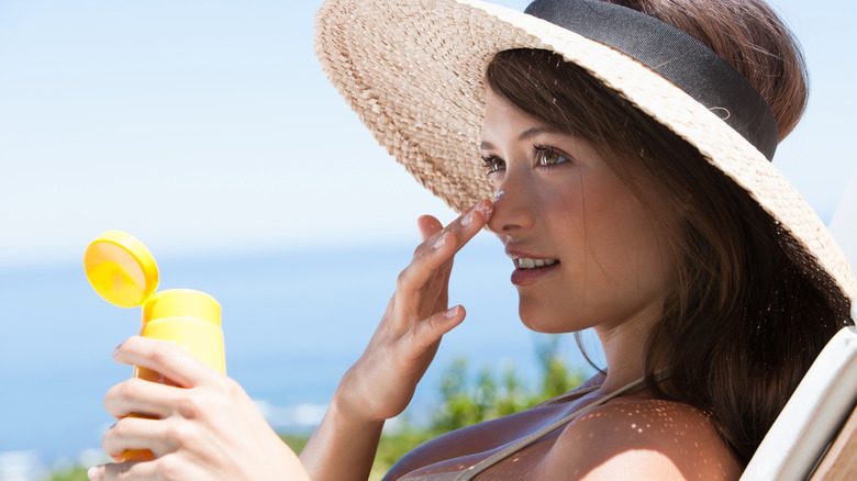 Woman applying sunscreen