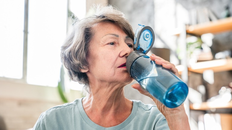 Older woman drinking water