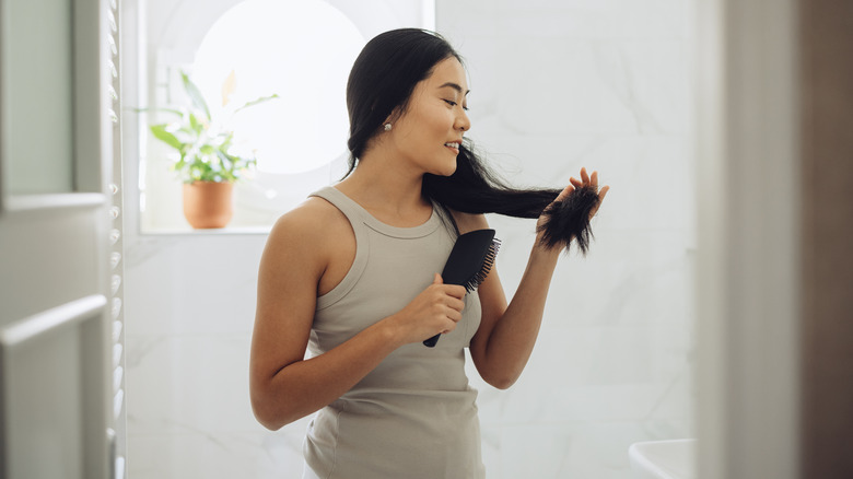 Woman looking at hair ends